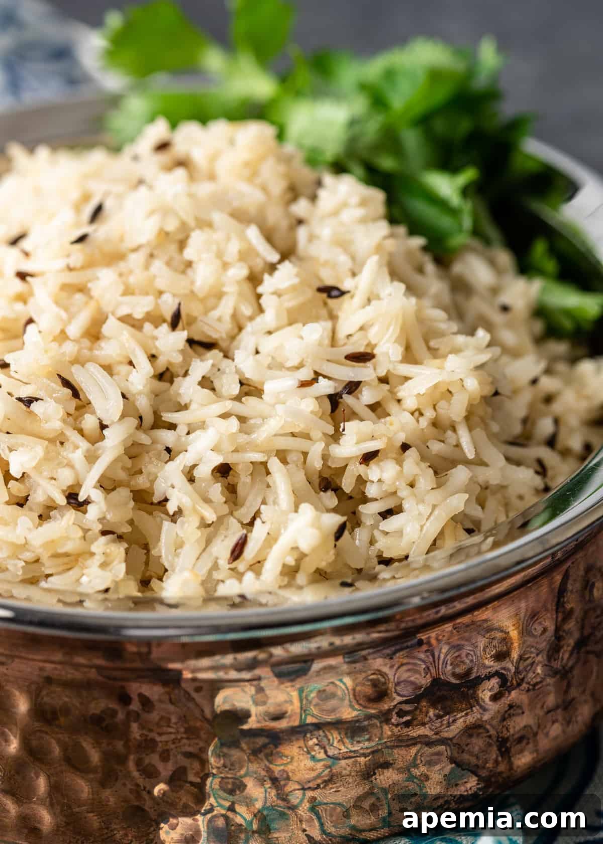 Aromatic Jeera Rice 4 close up: fluffy grains of jeera rice recipe in copper bowl