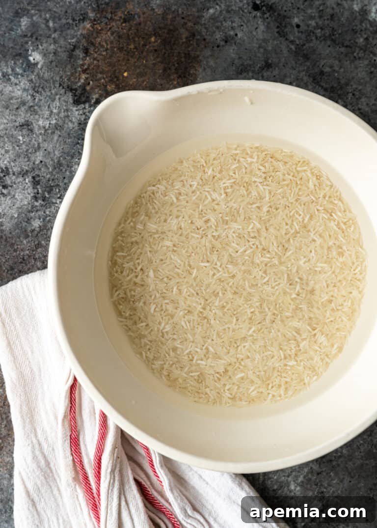 Aromatic Jeera Rice 5 overhead: basmati rice soaking in large white bowl