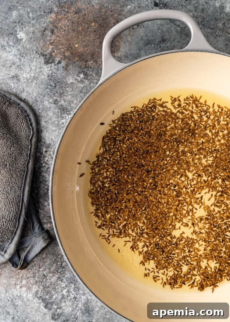 Aromatic Jeera Rice 6 overhead frying rice in oil for jeera rice recipe