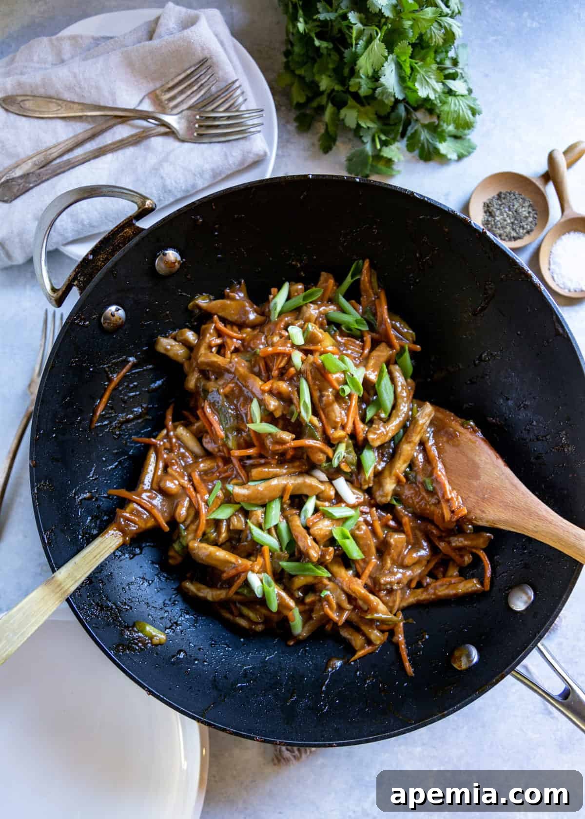 Overhead shot of Jeyuk Bokkeum being prepared in a wok, showing the colorful ingredients.