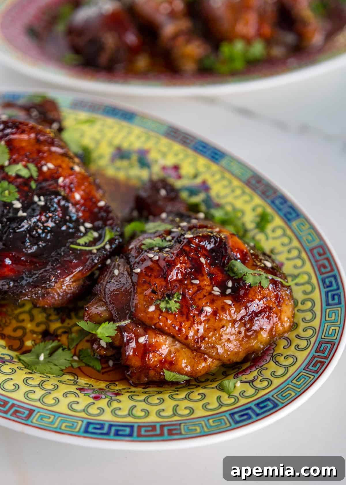 Platter of sticky Asian chicken with a generous coating of glaze, ready to be served