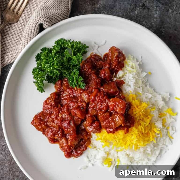 overhead: eggplant stew on plate with cooked rice