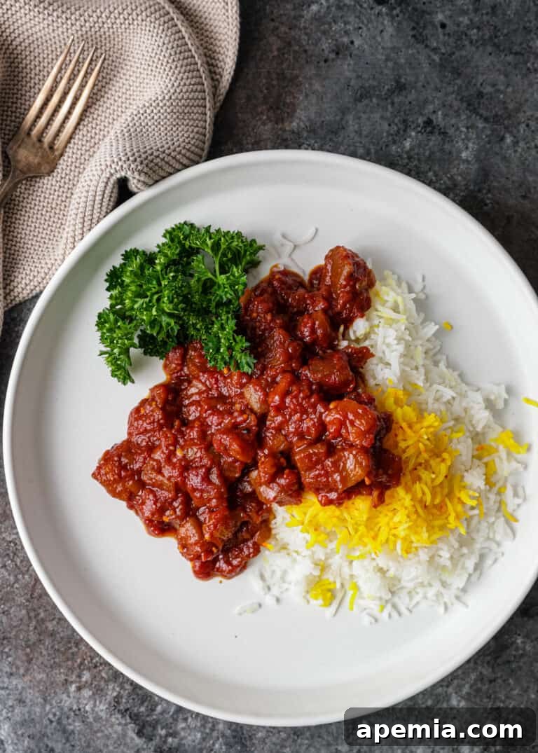 overhead: khoresh bademjan ladled over basmati saffron rice