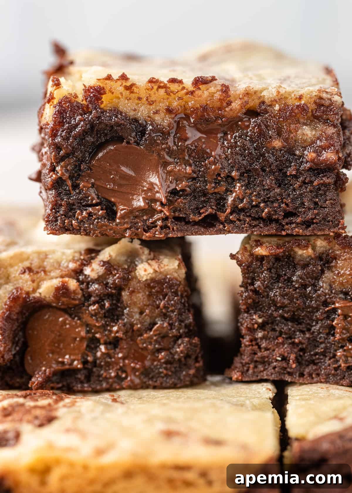 Close-up of a single slice of tahini brownie with a visible swirl of sesame paste on top, highlighting its fudgy texture.