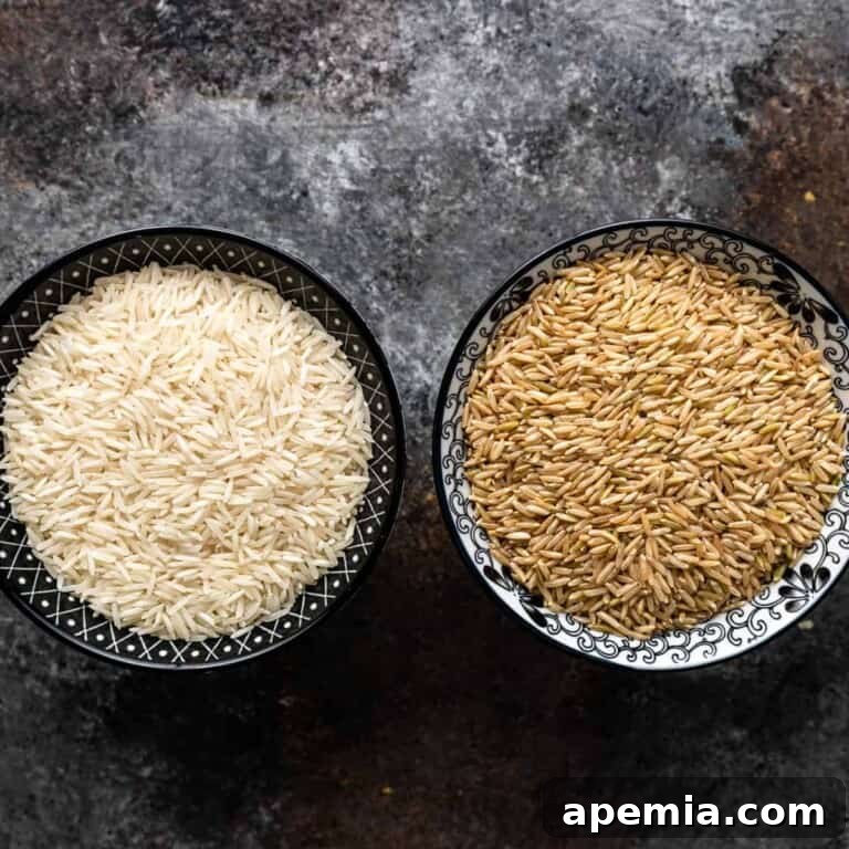 Two bowls, one with fluffy white basmati rice and another with fluffy brown basmati rice, showing the perfectly cooked grains side-by-side.