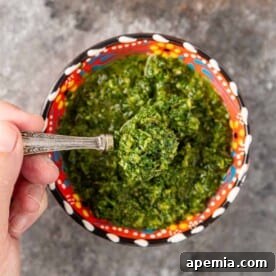 close up of a spoonful of fresh zhoug
