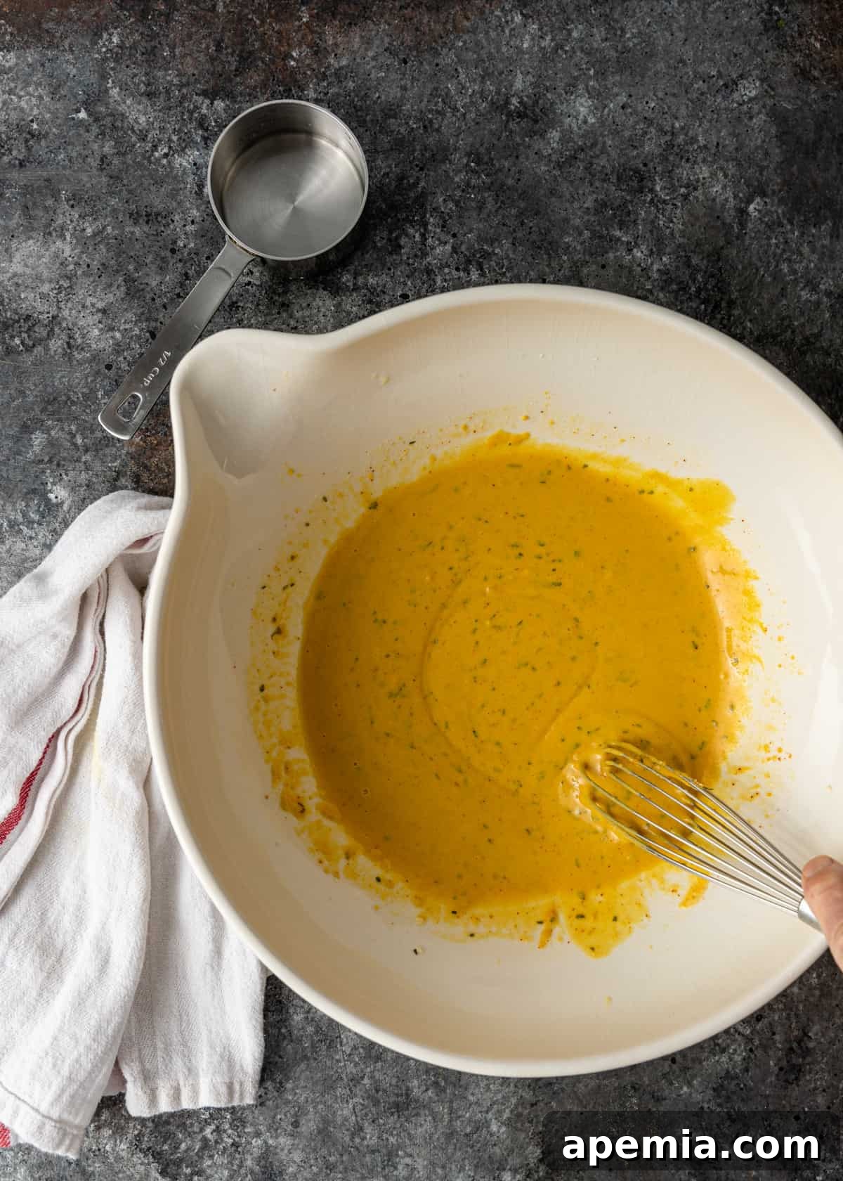 overhead process shot: a smooth, perfectly mixed wet pakora batter in a bowl, ready for dipping