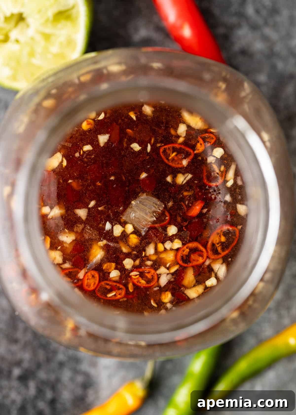 overhead closeup: my nuoc cham recipe in a glass jar with spices and seasonings showing