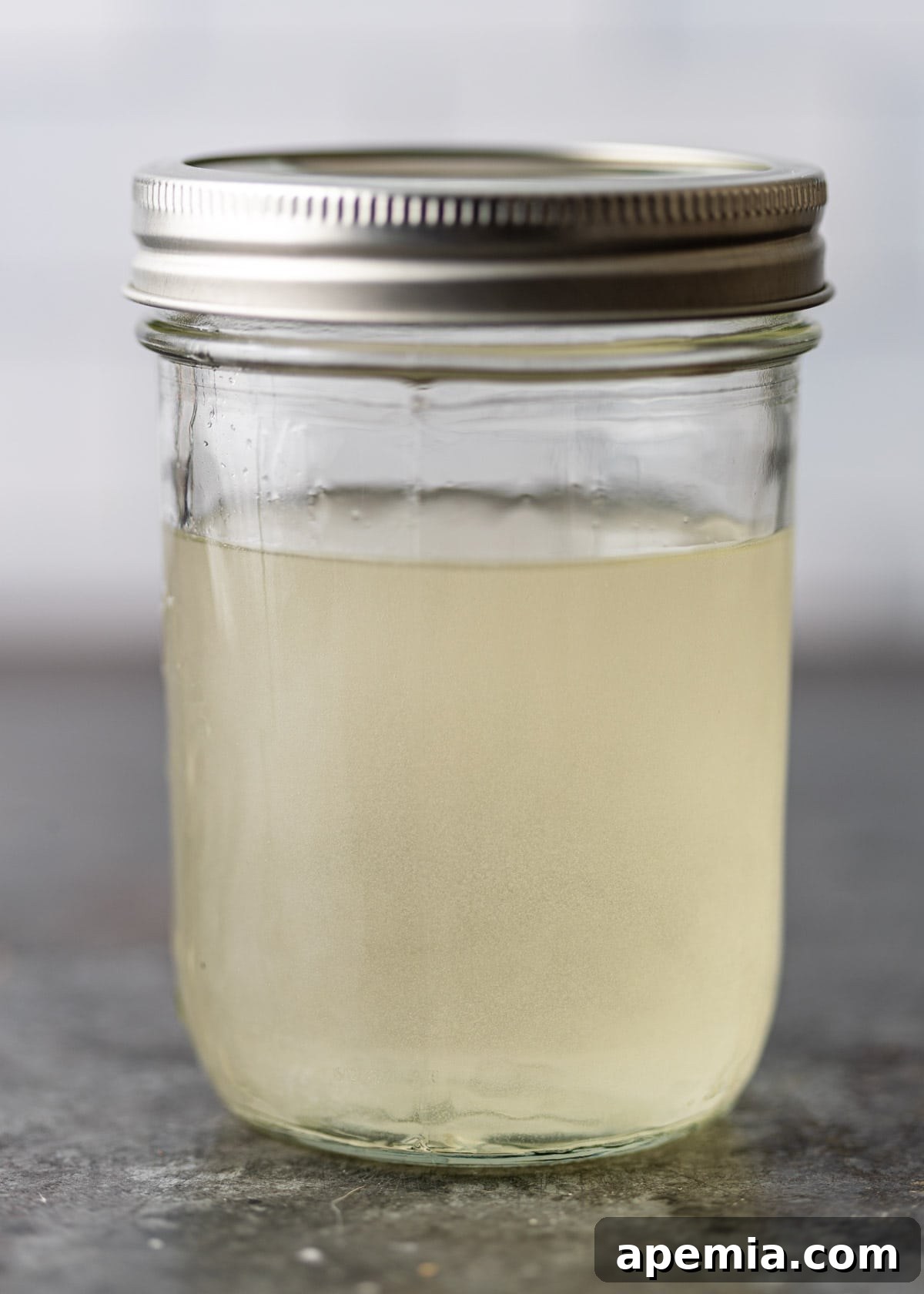 process shot: sugar shaken in hot water to dissolve