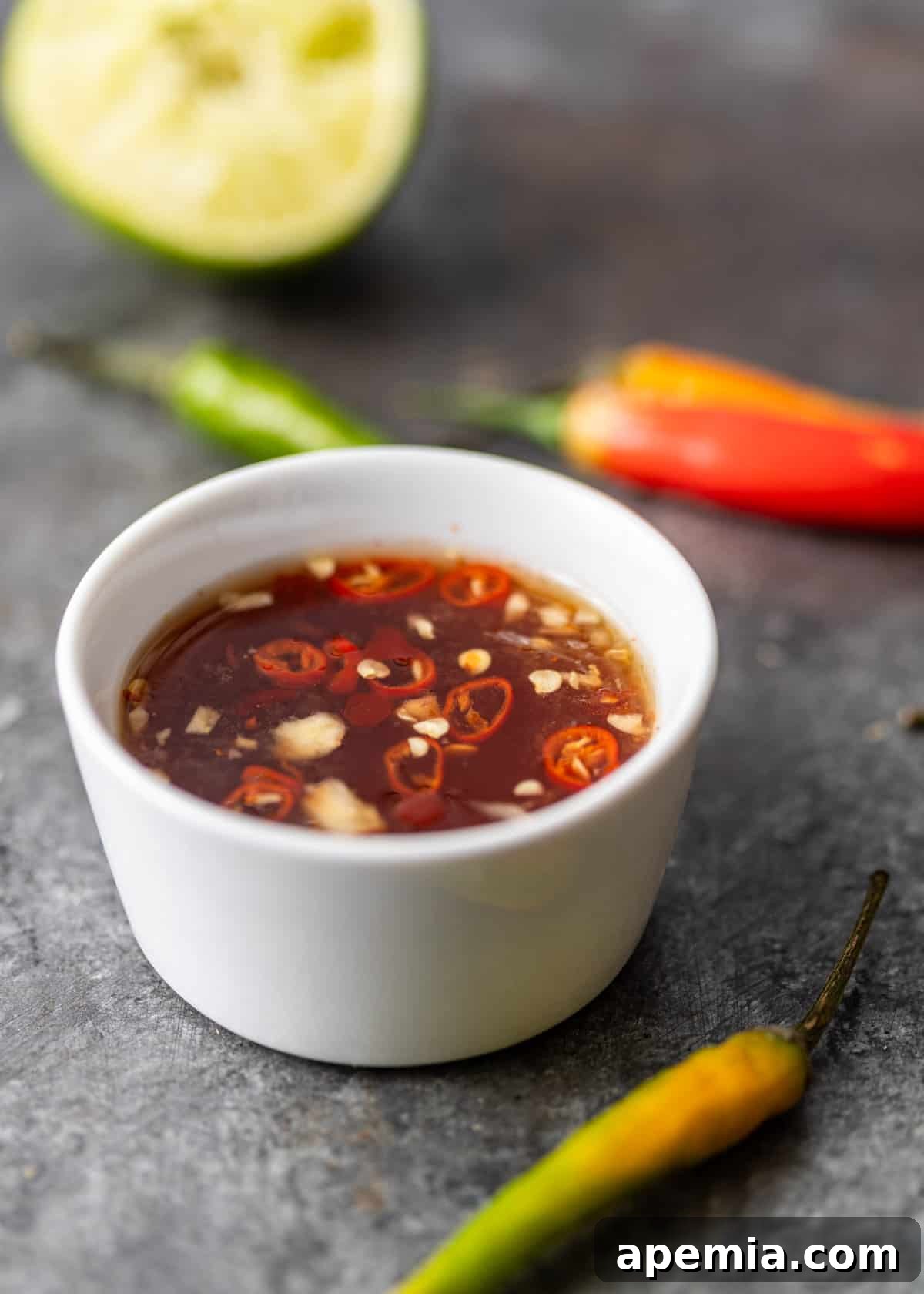 a small white ramekin with nuoc mam