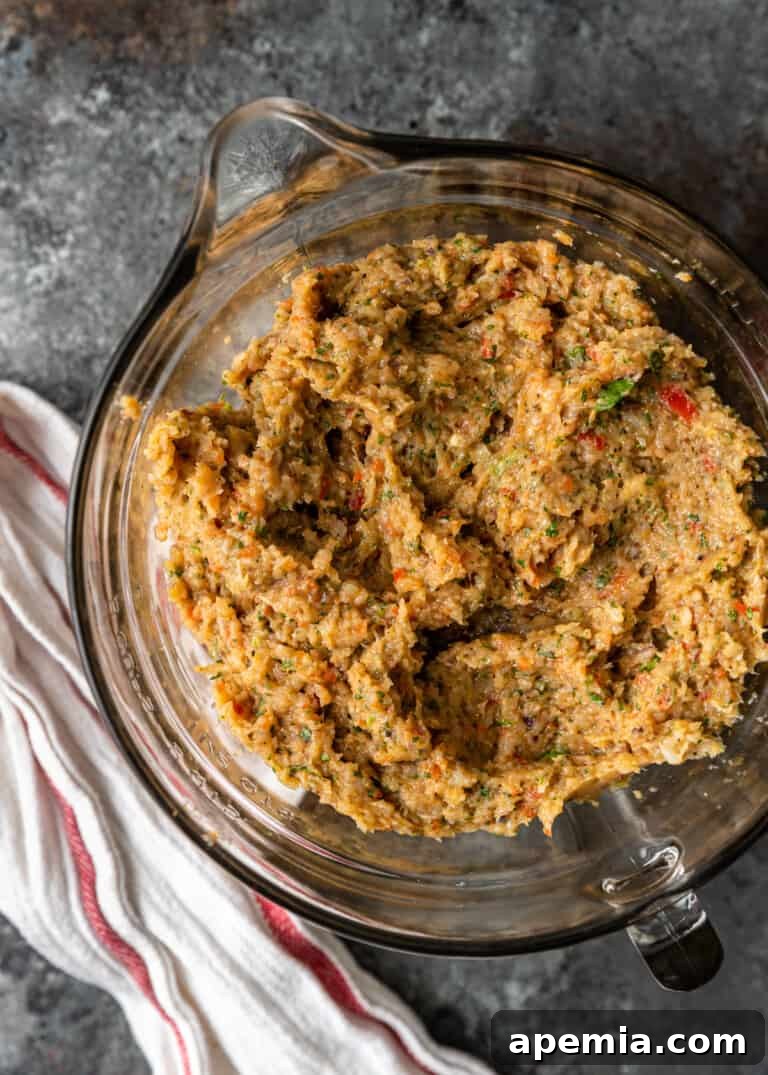 Close-up of the finely ground and seasoned chicken koobideh meat mixture in a bowl, ready for shaping.