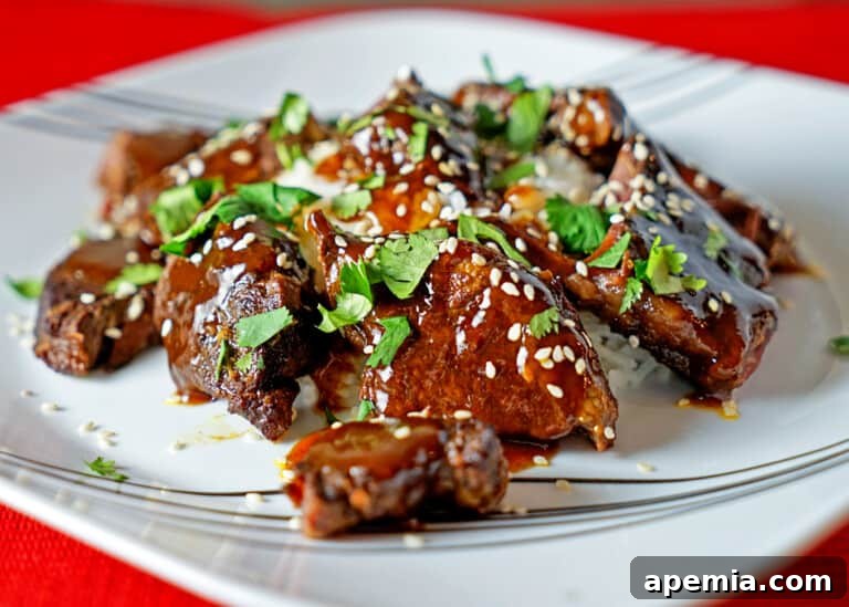 slow cooked sticky Asian beef short ribs on white plate ready to be served