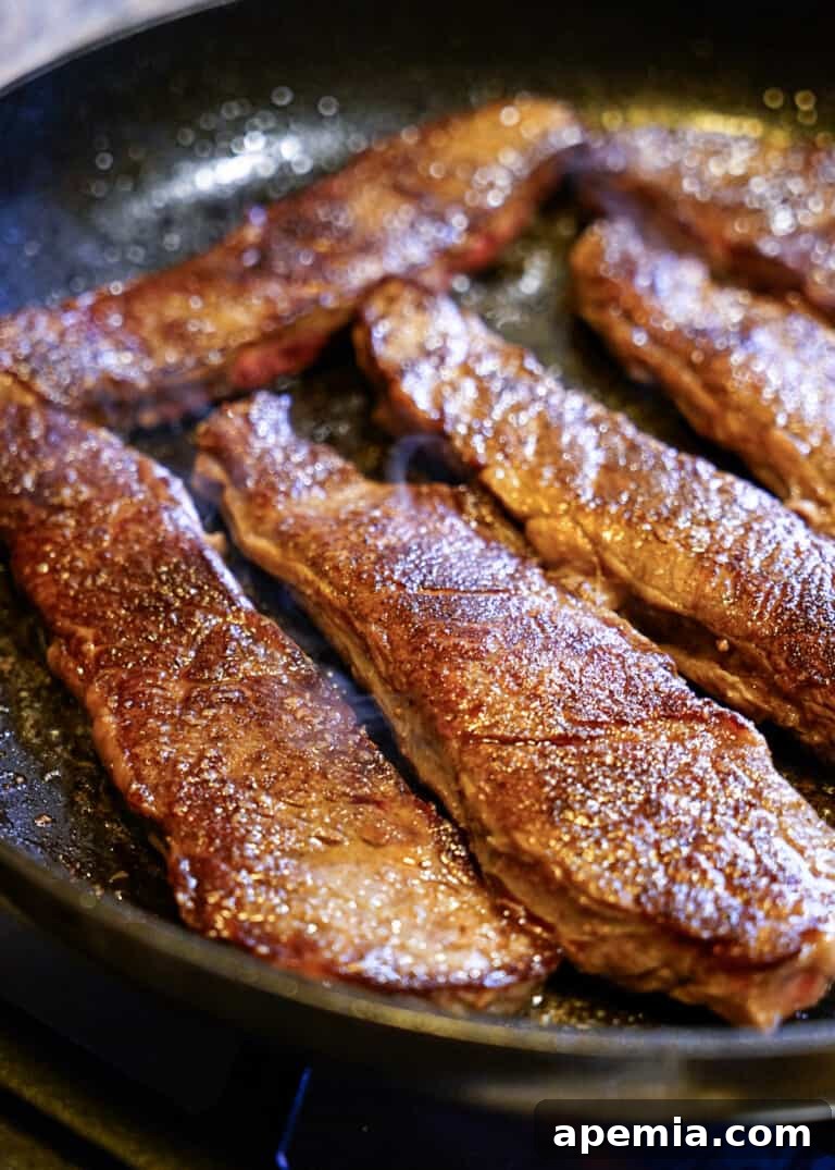 searing boneless short ribs in a hot skillet for flavor development
