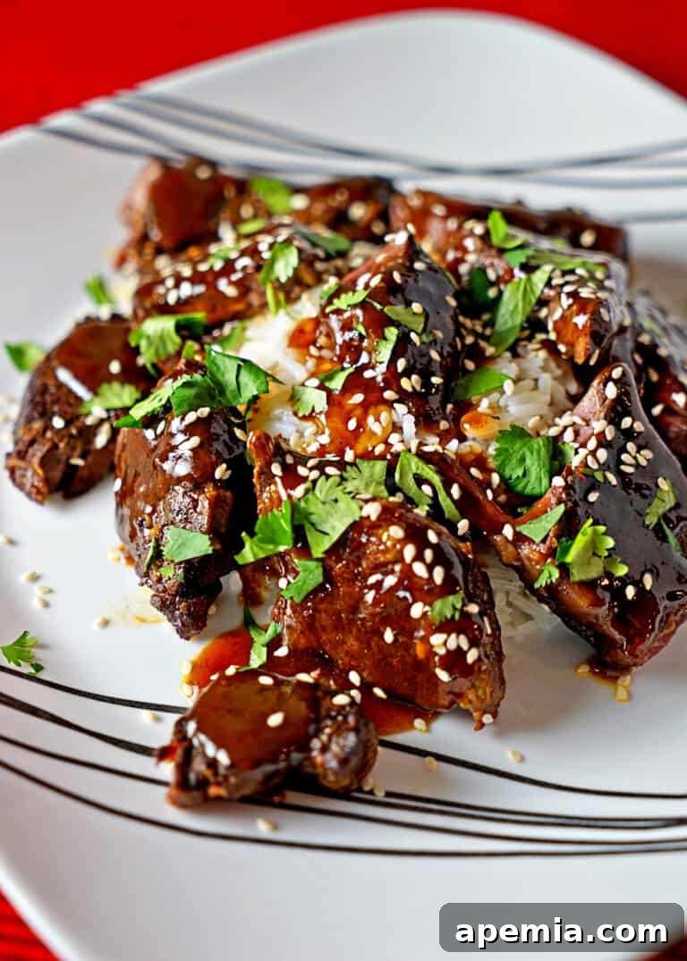 closeup: Asian short ribs coated in sticky sauce and sesame seeds