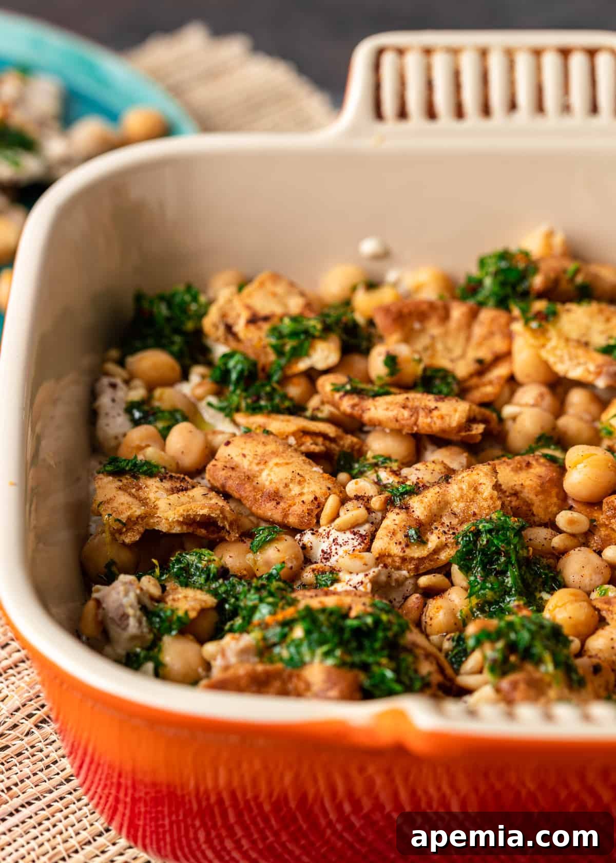 fattet hummus in square red dish