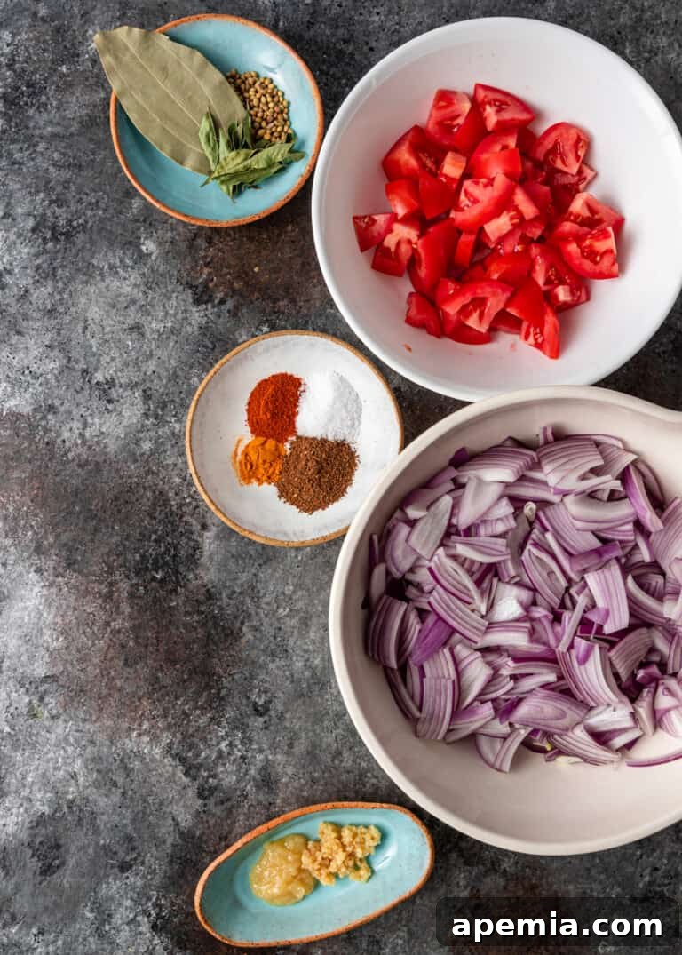 Small bowls showcasing the essential spices and fresh ingredients for Gobi Masala gravy.