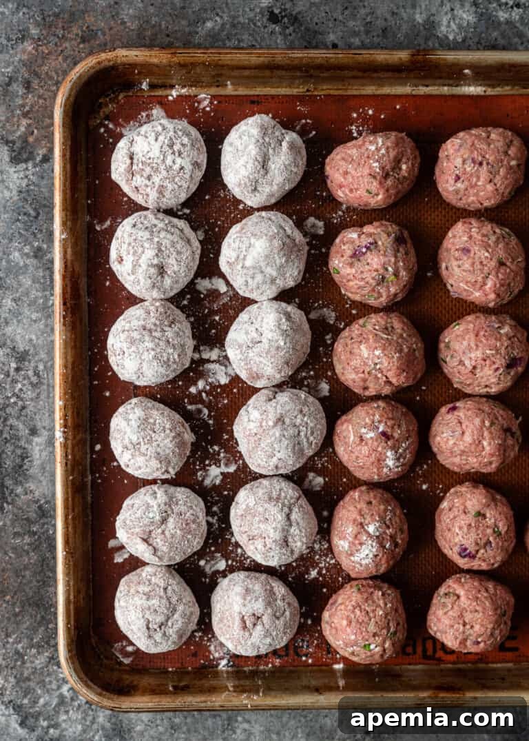 Authentic Pan-Fried Greek Lamb Keftedes 6 overhead: rolled Greek meatballs, some already rolled in flour for frying