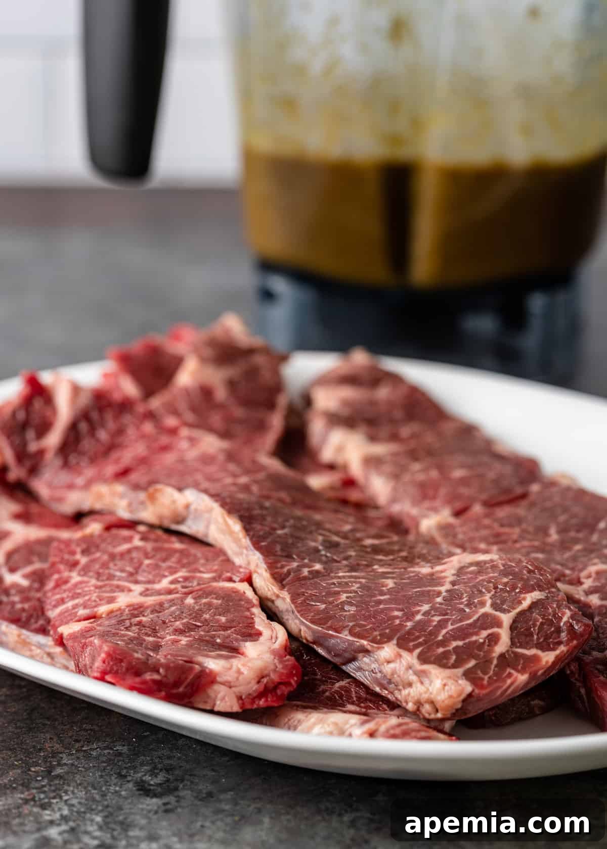 Beef ribs on plate with blender of bulgogi marinade in background