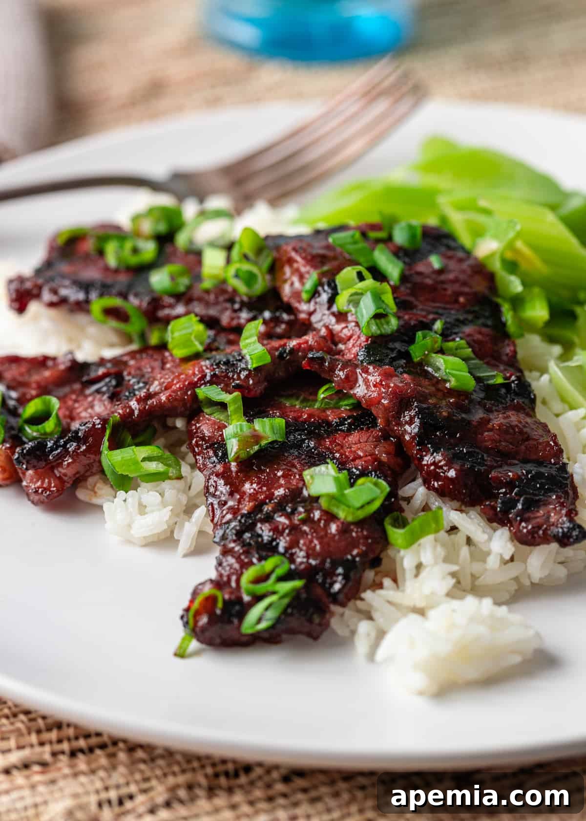 Kalbi recipe over white rice on white plate