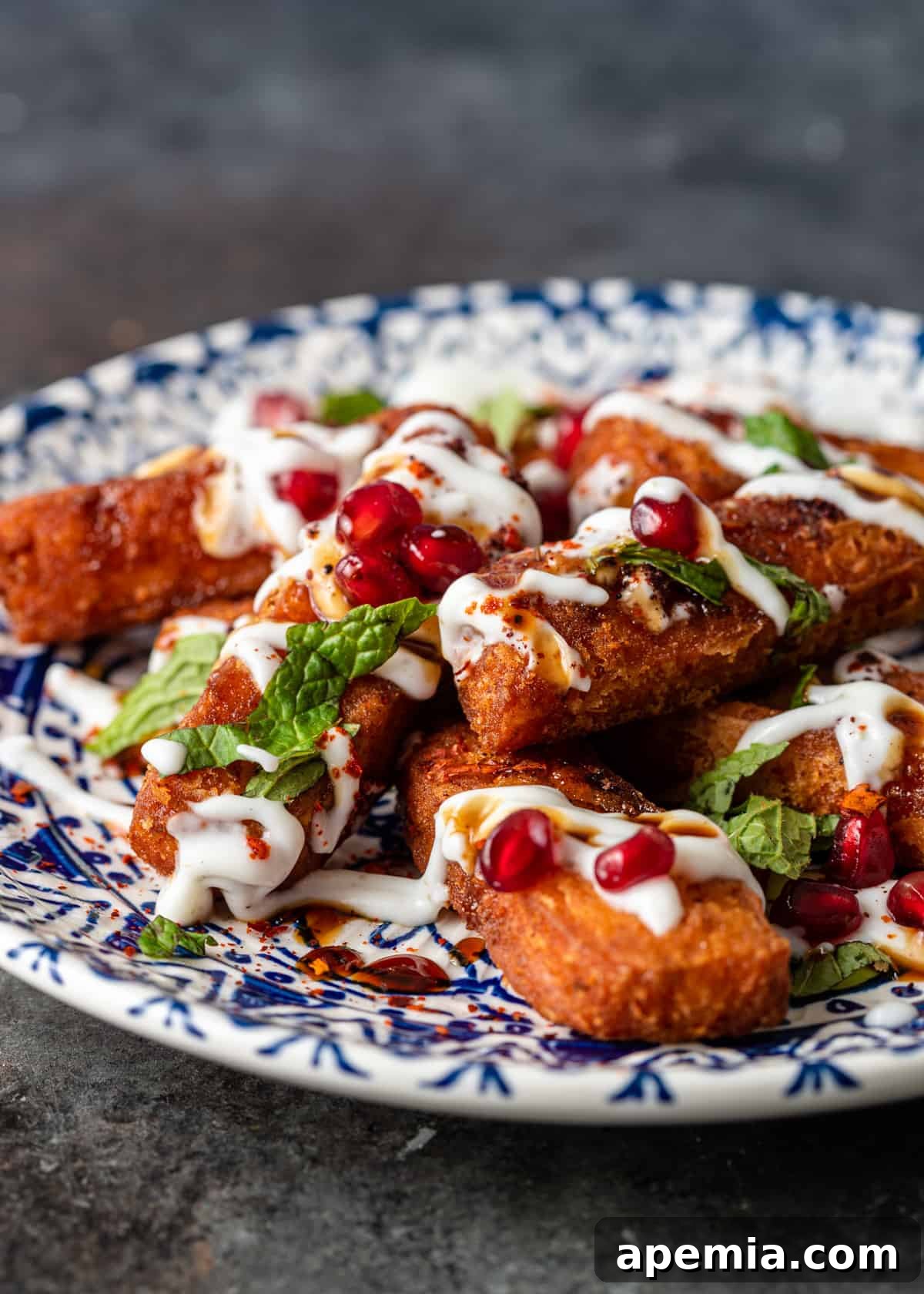 Close-up of a platter generously stacked with freshly fried, crispy halloumi fries, glistening golden.