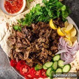 Close-up shot of a serving of shredded lamb shawarma, indicating the tender texture and delicious appearance, ready to be enjoyed.