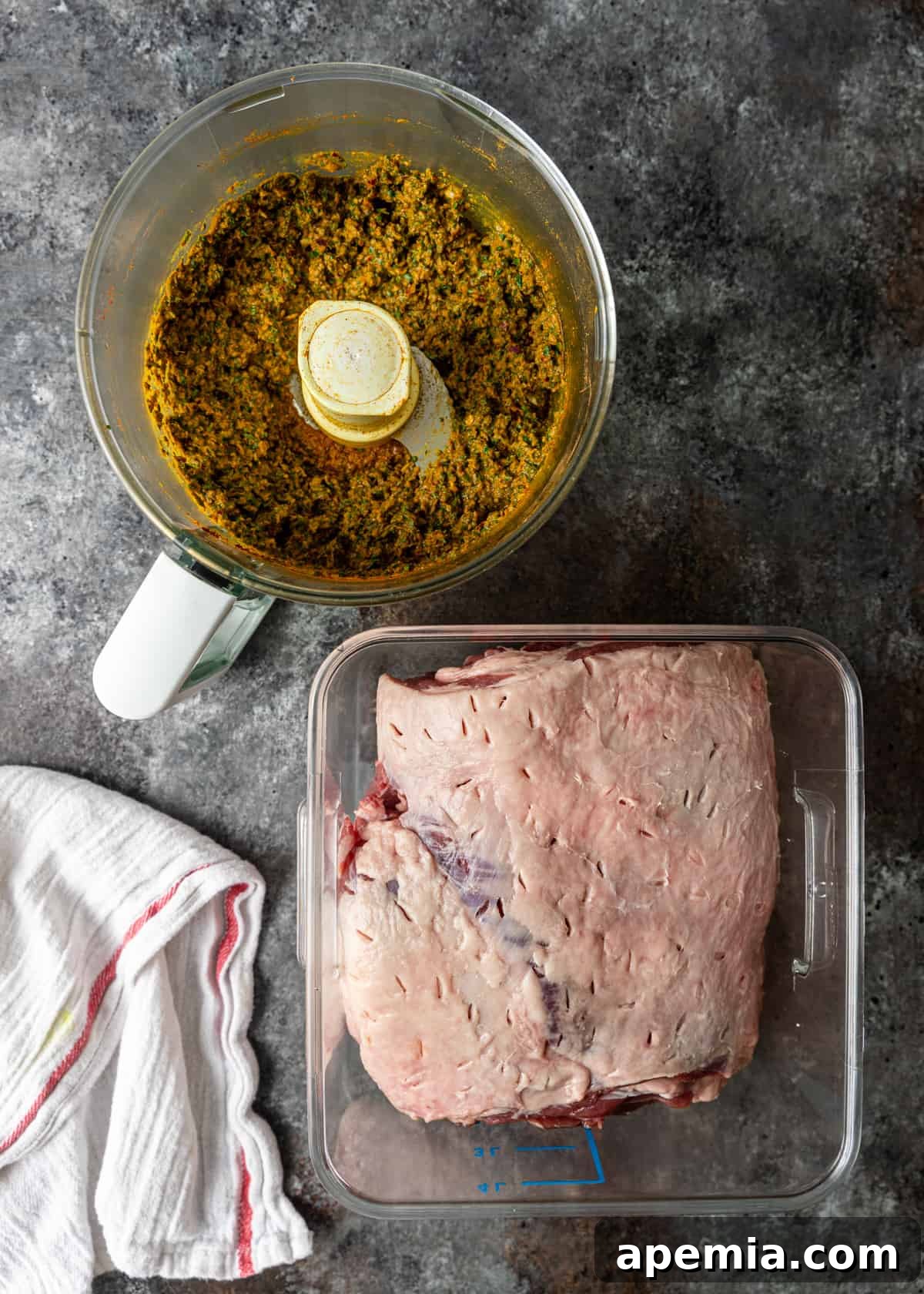 Overhead process shot demonstrating how to poke small holes into a piece of raw lamb shoulder, preparing it for marinade absorption.