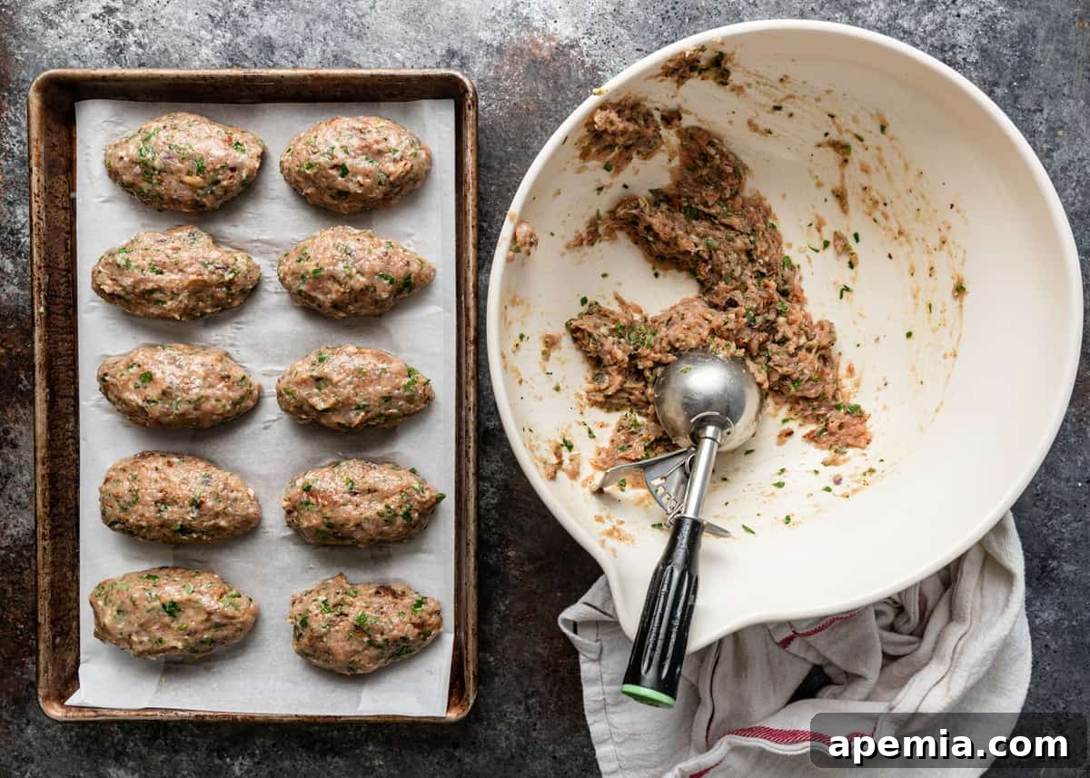 overhead: chicken kofta mixture on tray with more in bowl with scoop