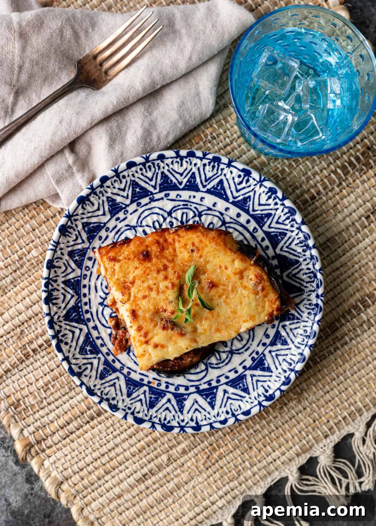 A perfectly portioned slice of moussaka on a plate, revealing its delicious layers.