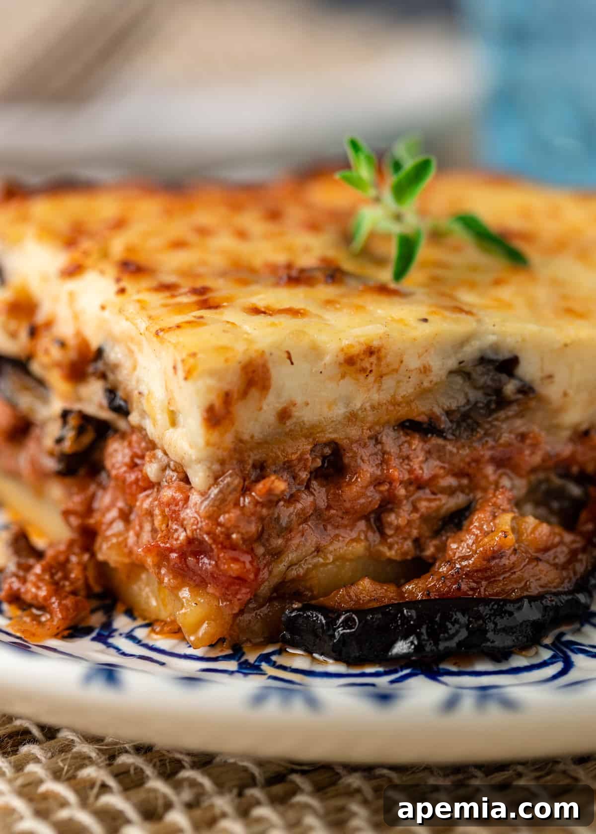 A close-up view of a freshly baked Greek moussaka, golden brown and bubbling.