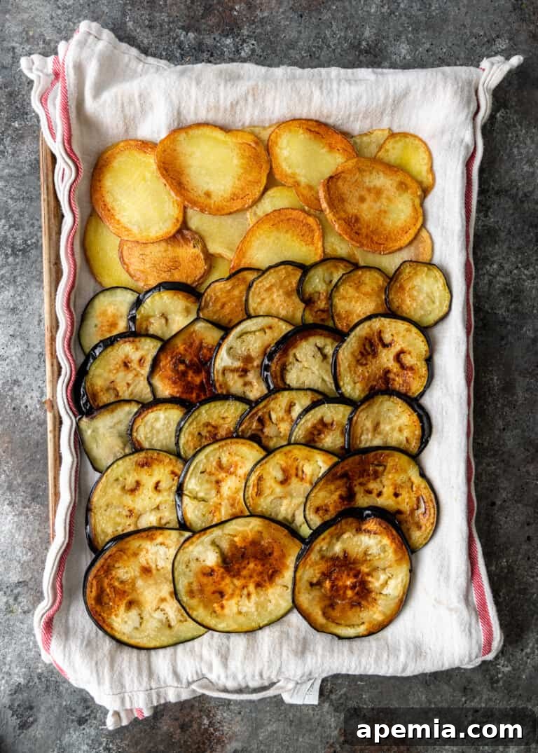 Cooked, golden-brown slices of eggplant, ready for layering in moussaka.
