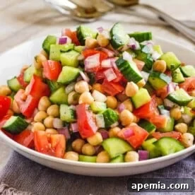 white bowl of shirazi salad at table setting