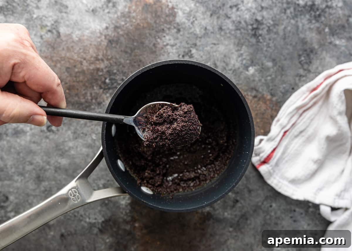 Overhead view of a bowl of ready-to-serve poppy seed filling, garnished slightly and ready for incorporation into desserts.
