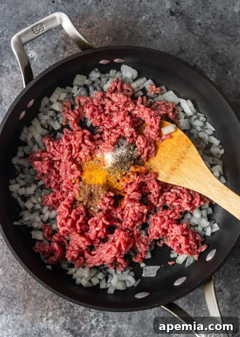 overhead process shot: filling for stuffed zucchini in skillet