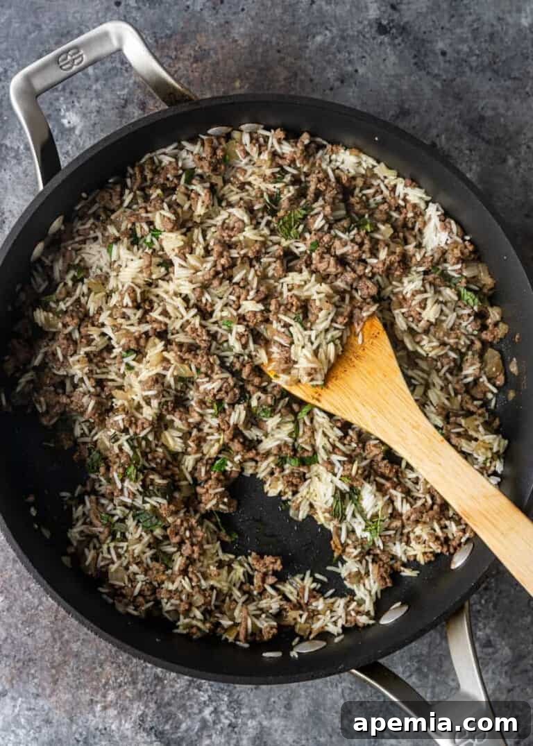 overhead process shot: cooked rice and beef filling in pan