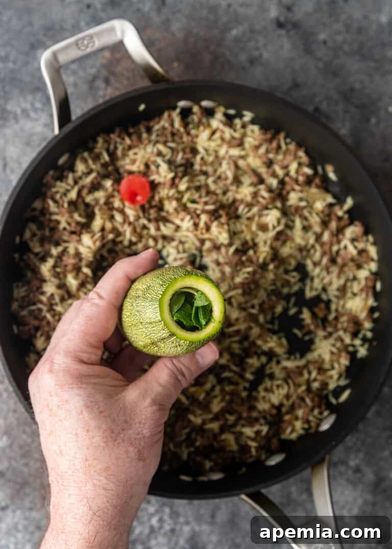 overhead process shot: topping stuffed squash with mint
