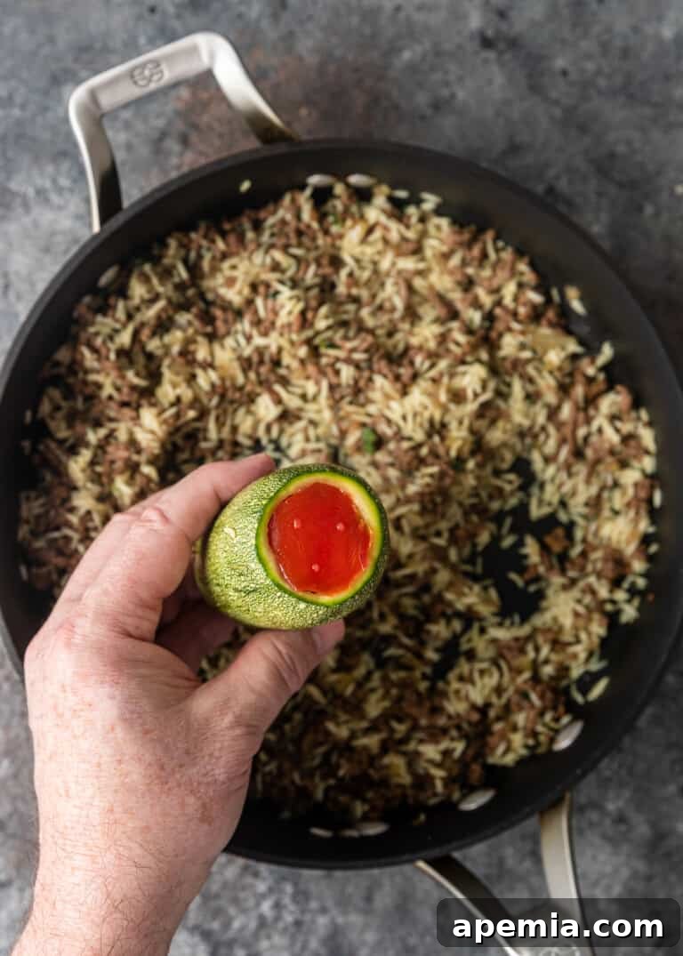 overhead process shot: adding tomato to bottom of zucchini as a plug