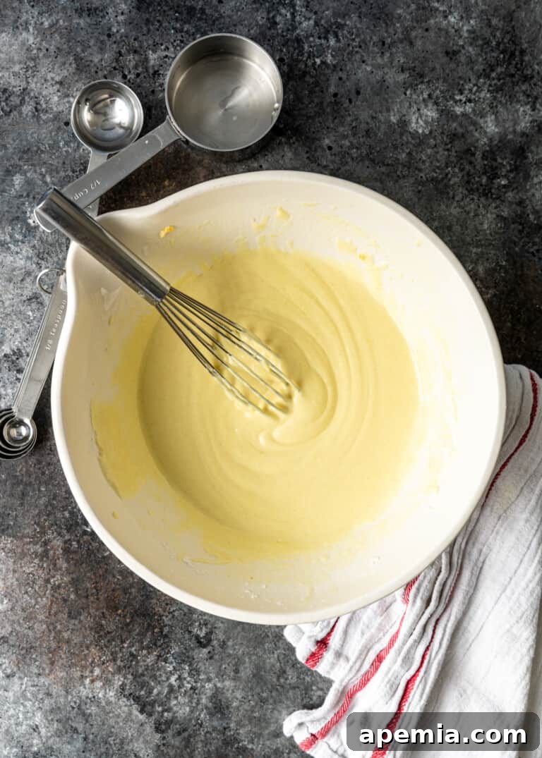 overhead shot of thoroughly mixed jalebi recipe batter in a bowl