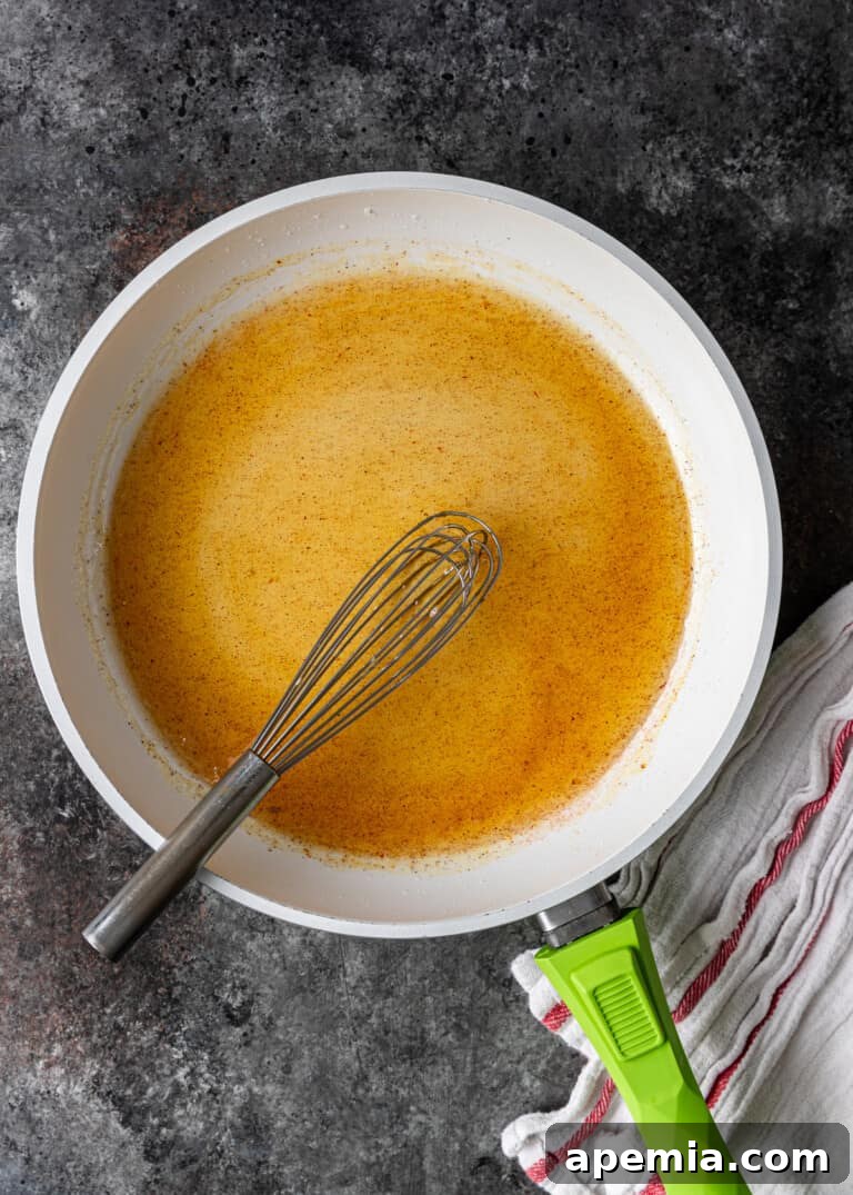 overhead shot of saffron and cardamom being added to the syrup for jalebi