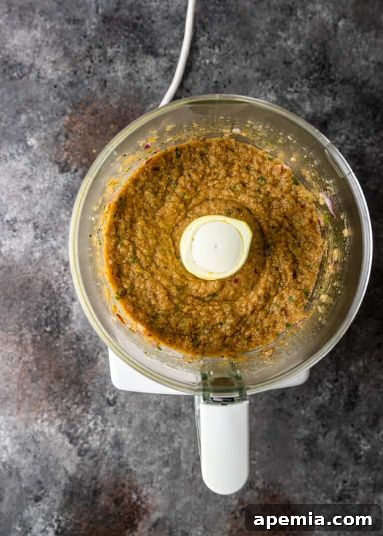 Grecian Smoked Eggplant Puree 7 Blended Melitzanosalata in a food processor, showing its creamy texture.