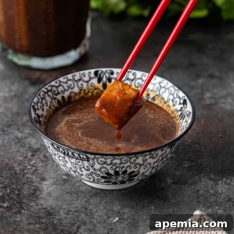 Tofu with chopsticks in ginger sauce