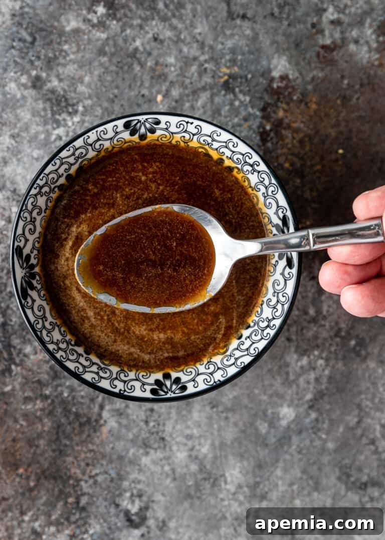 top view of spoon in bowl with ginger sauce