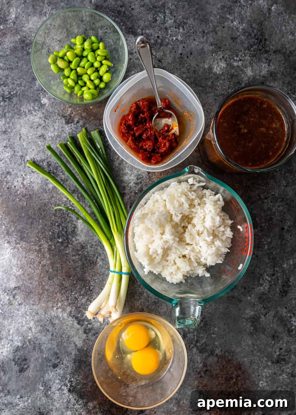 overhead shot: organized ingredients for Japanese fried rice, including char siu, eggs, vegetables, and oils