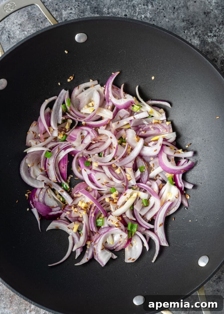 overhead process shot: onions cooking in a wok