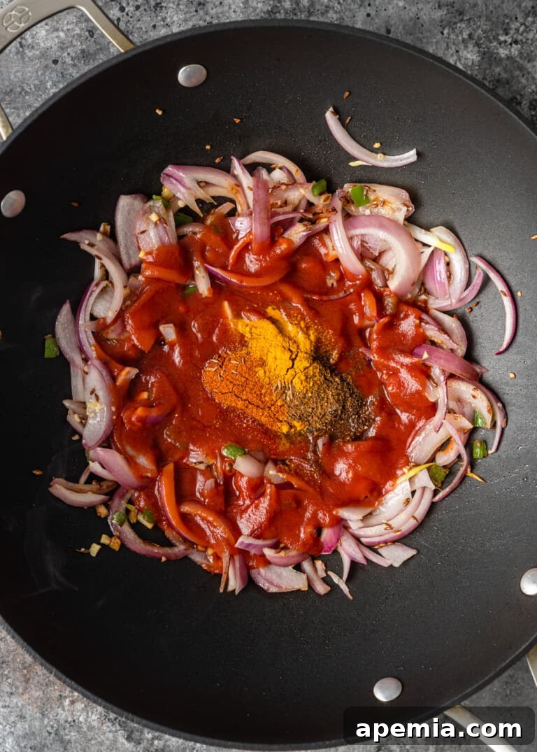 overhead process shot: onions and seasonings in a wok