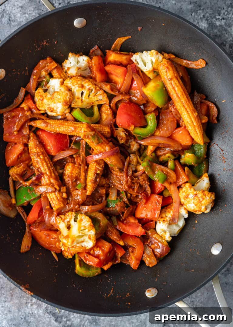 overhead process shot: veggie jalfrezi cooking in a wok