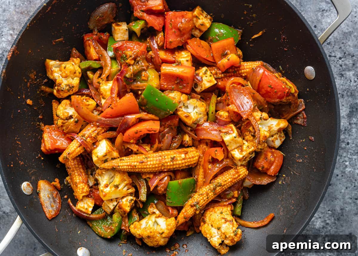 overhead: cooked vegetable jalfrezi in a wok