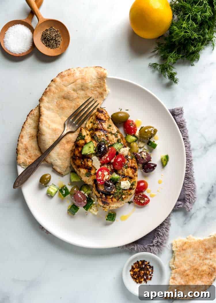 Overhead shot of Mediterranean Grilled Chicken beautifully arranged on a plate with fresh bread.