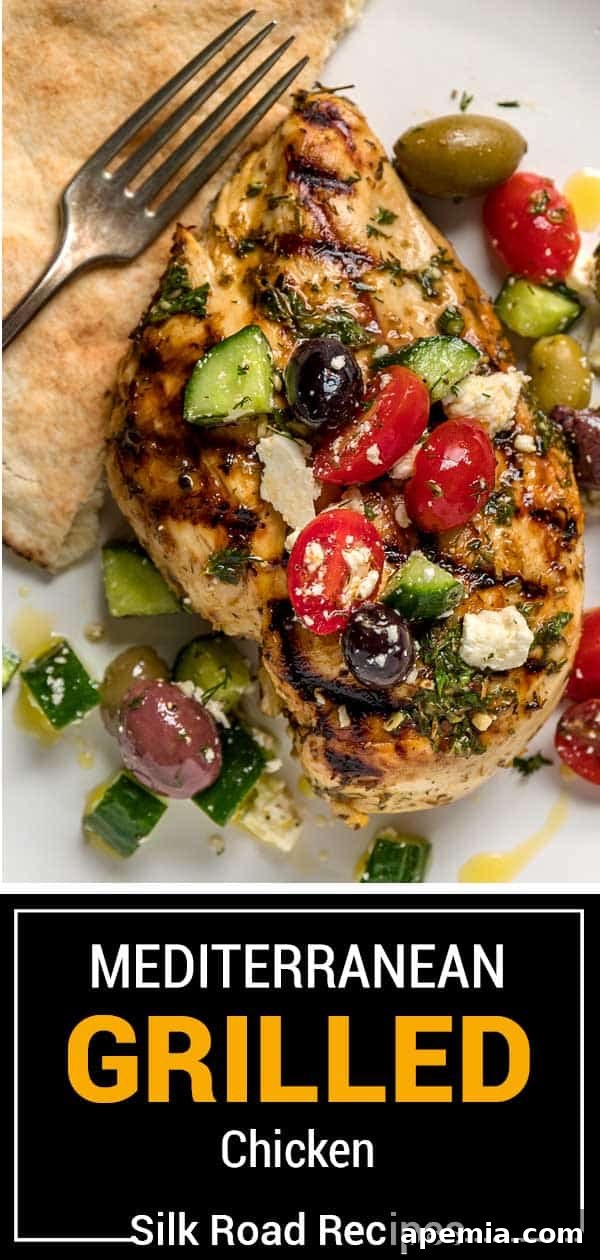 Grilled marinated chicken with fresh tomatoes and olives on top, ready to be served.