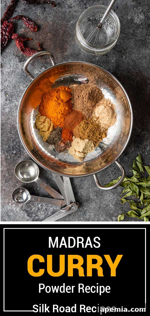 All the whole spices laid out on a wooden surface, ready to be toasted for Madras Curry Powder.