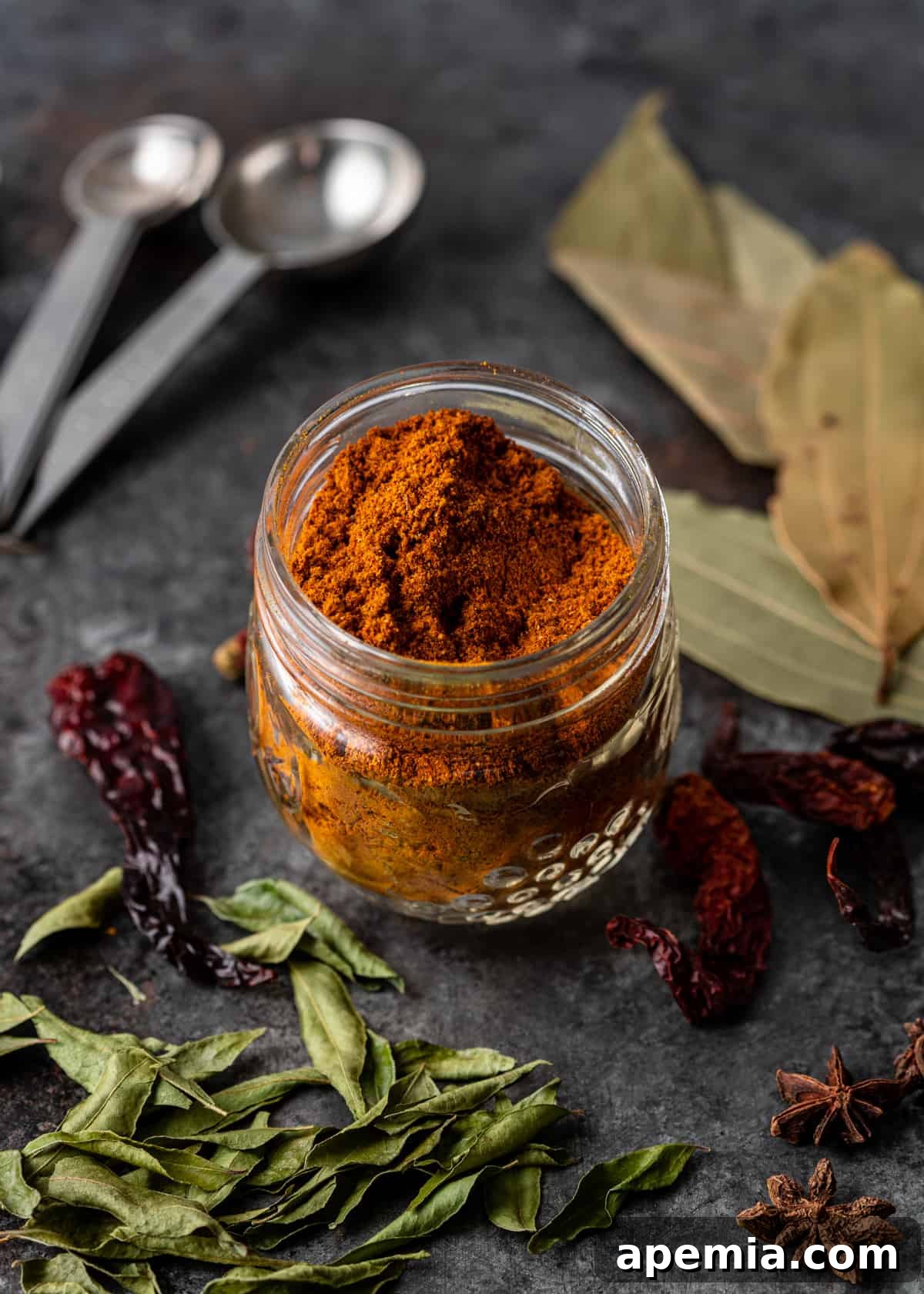 Glass jar filled with vibrant red Vindaloo Curry Powder